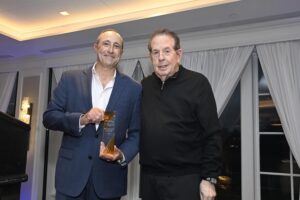 two men standing with an award